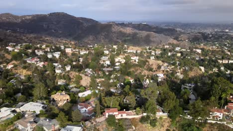 aerial view flying across vast residential urban real estate hollywood countryside mountain landscape dolly right