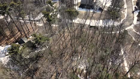 An-Aerial-track-of-a-delivery-van-across-melting-snow-streets