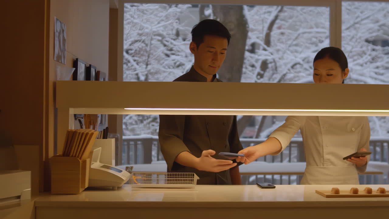 Restaurant staff conducting a mobile payment transaction