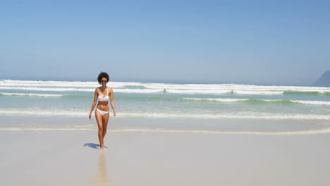 Woman-having-fun-at-beach-on-a-sunny-day-4k