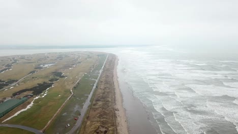 aerial view of royal and ancient golf club of st andrews and rough sea, scotland