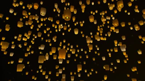 asian sky lanterns flying in the night sky