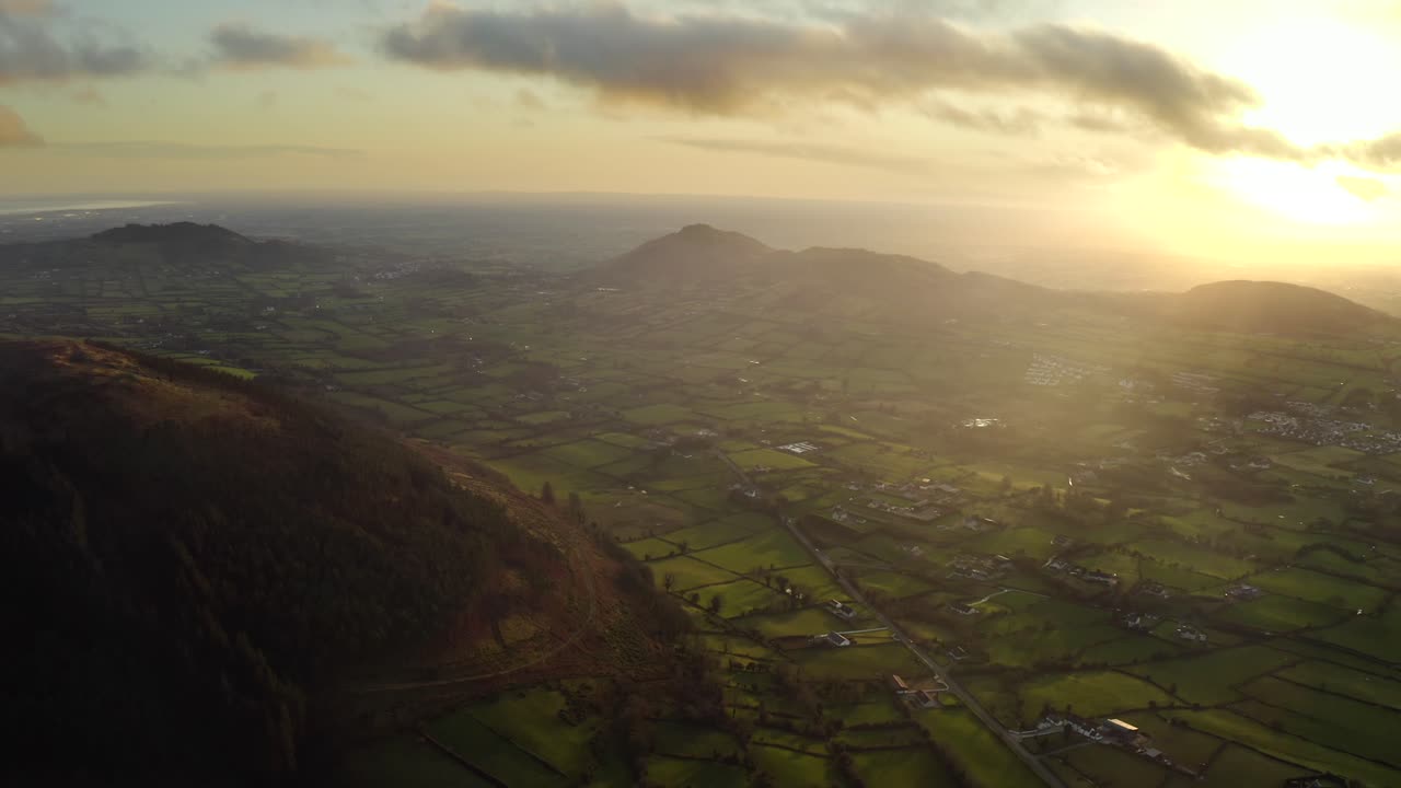 Wintery sunset at Ring of Gullion, Newry, Northern Ireland. December 2019. Drone slowly tracks away from Slieve Gullion facing South towards Forkill.