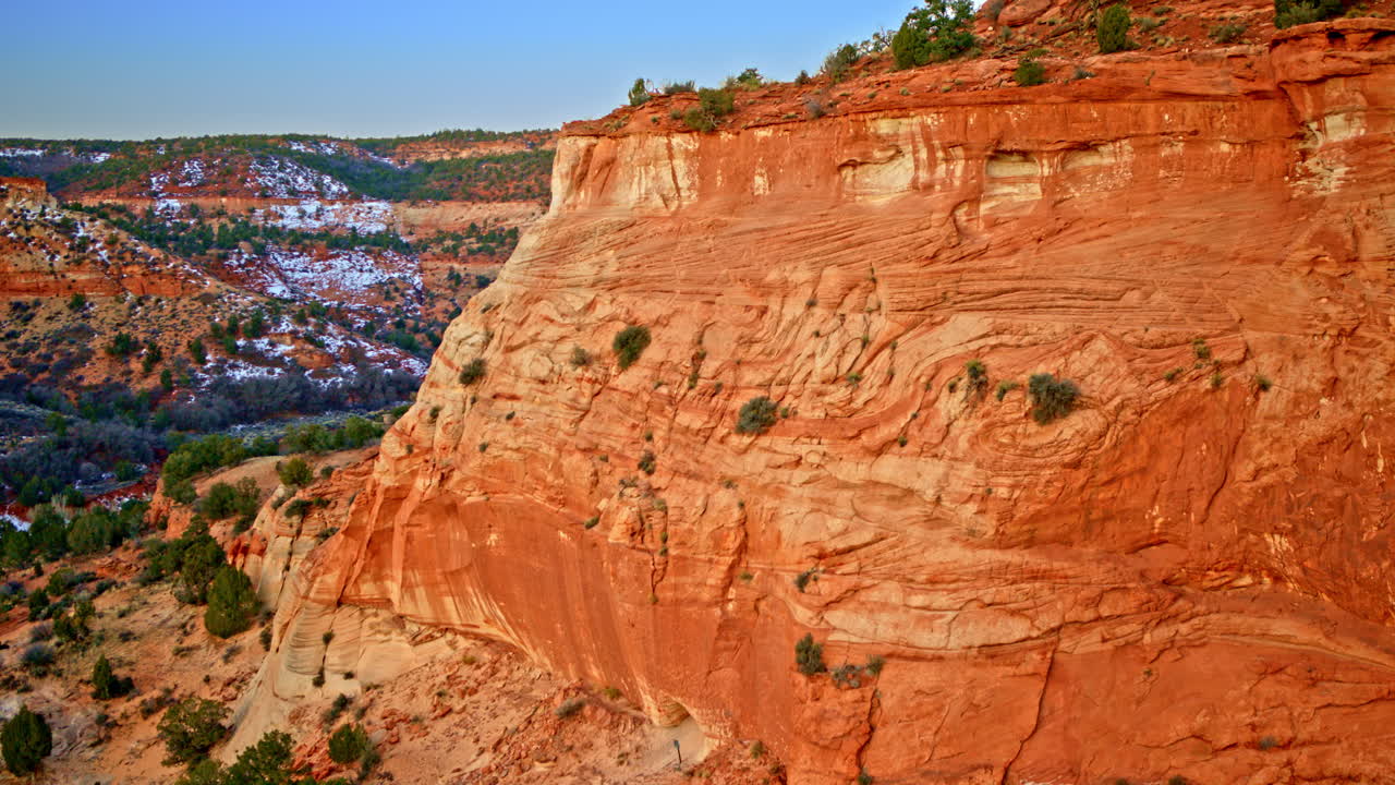 The camera floats over surreal, weather-worn canyonlands close to Page, Arizona.