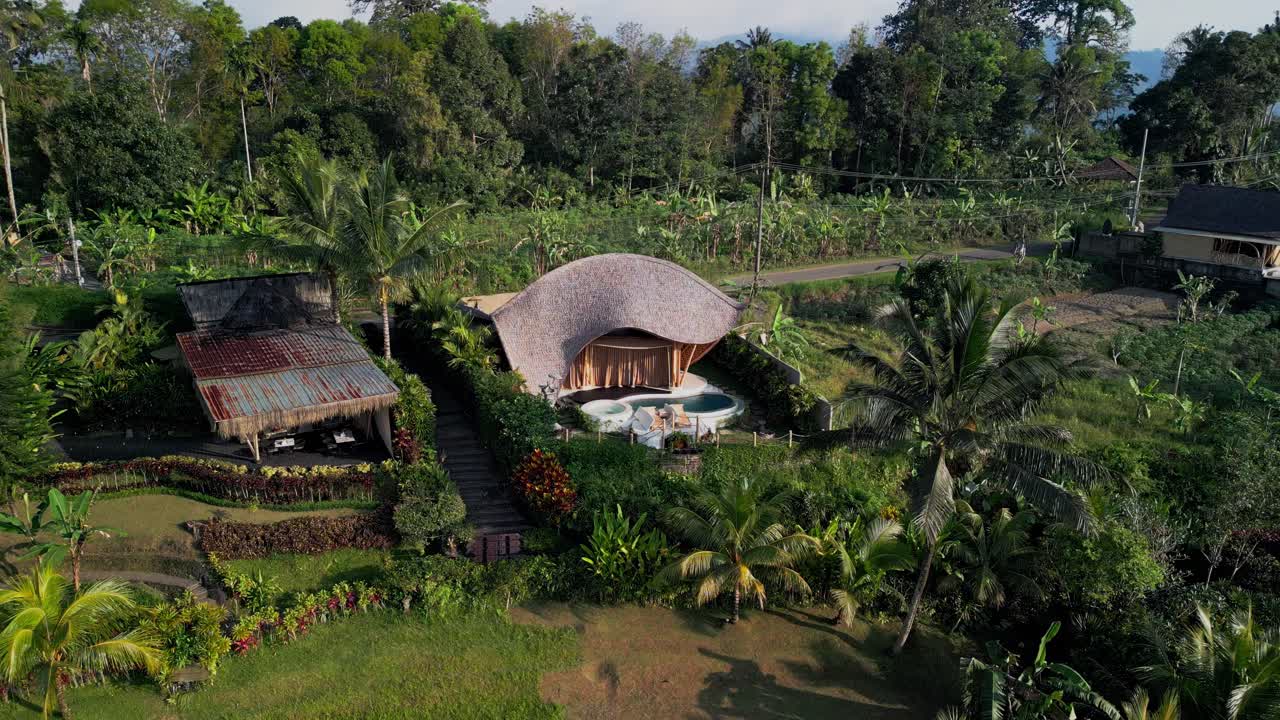Sidemen Bali bamboo retreat highlights wooden architecture, green garden, natural pool and quiet rural charm, offering guests an authentic island hideaway with cultural inspiration