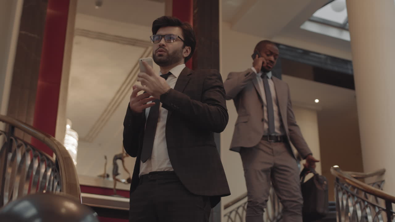 Manager Talking on Phone on Staircase