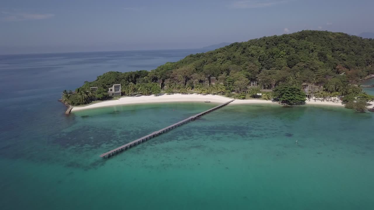 Aerial view of paradise island Koh Kham,Thailand backwards from pier towards open sea. Full view of the island.