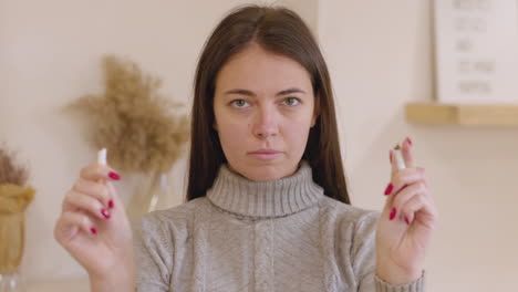 Woman-Deciding-To-Quit-Smoking-And-Breaking-Cigarette,-Looking-At-Camera