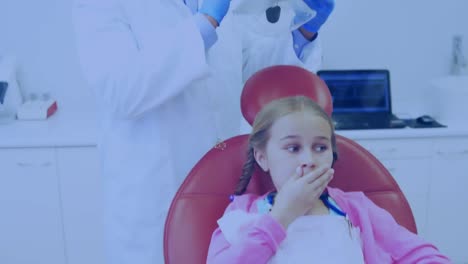 Animation-of-networks-of-connections-with-icons-over-girl-in-dentist-chair