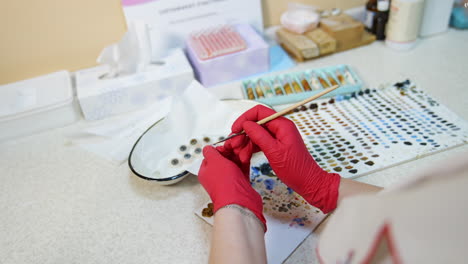glass eye prosthetic production. close up of coloring artificial eye prosthesis