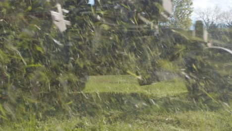 White-person-on-lawn-tractor-mowing-a-lawn-in-rural-America---low-angle