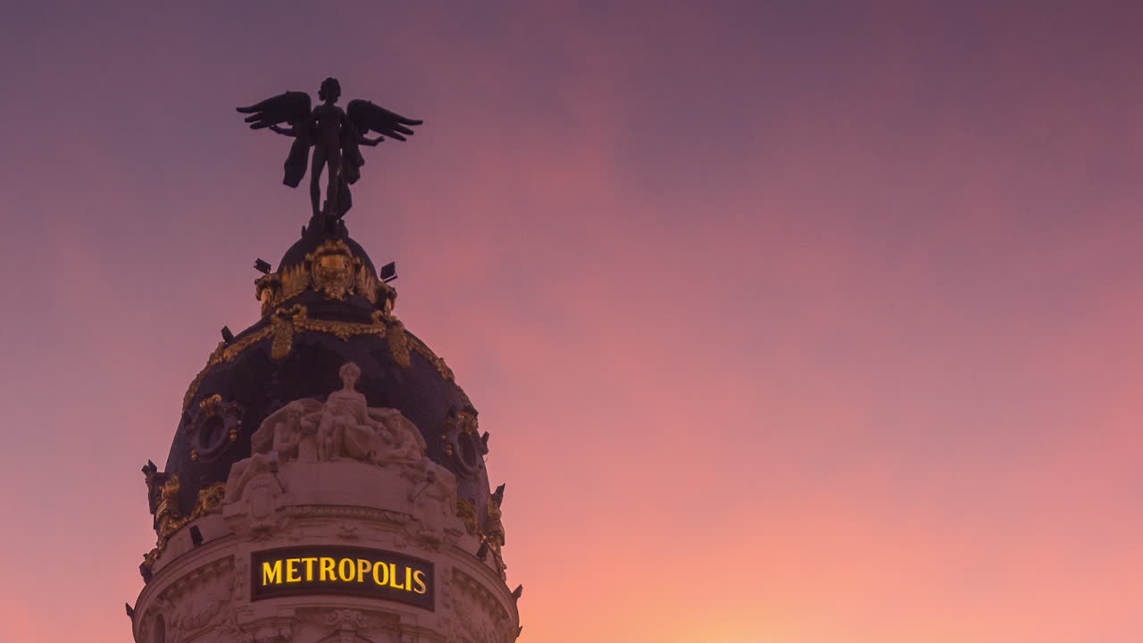 Timelapse of  Gran Via street in Madrid, Spain.  Beautiful sunset  and Metropoli building.