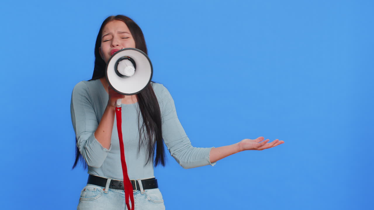 Happy woman talking with megaphone proclaiming news loudly announcing advertisement discounts sale