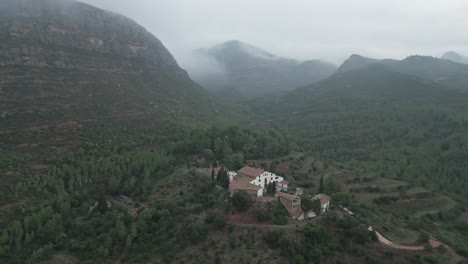 beautiful farmhouse in middle of misty mountains near montserrat, catalonia