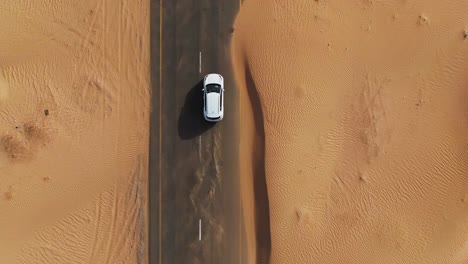 white car on a desert road - aerial view