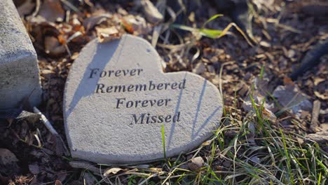 stone heart-shaped marker on ground signaling remembrance, love, regret, and eternity