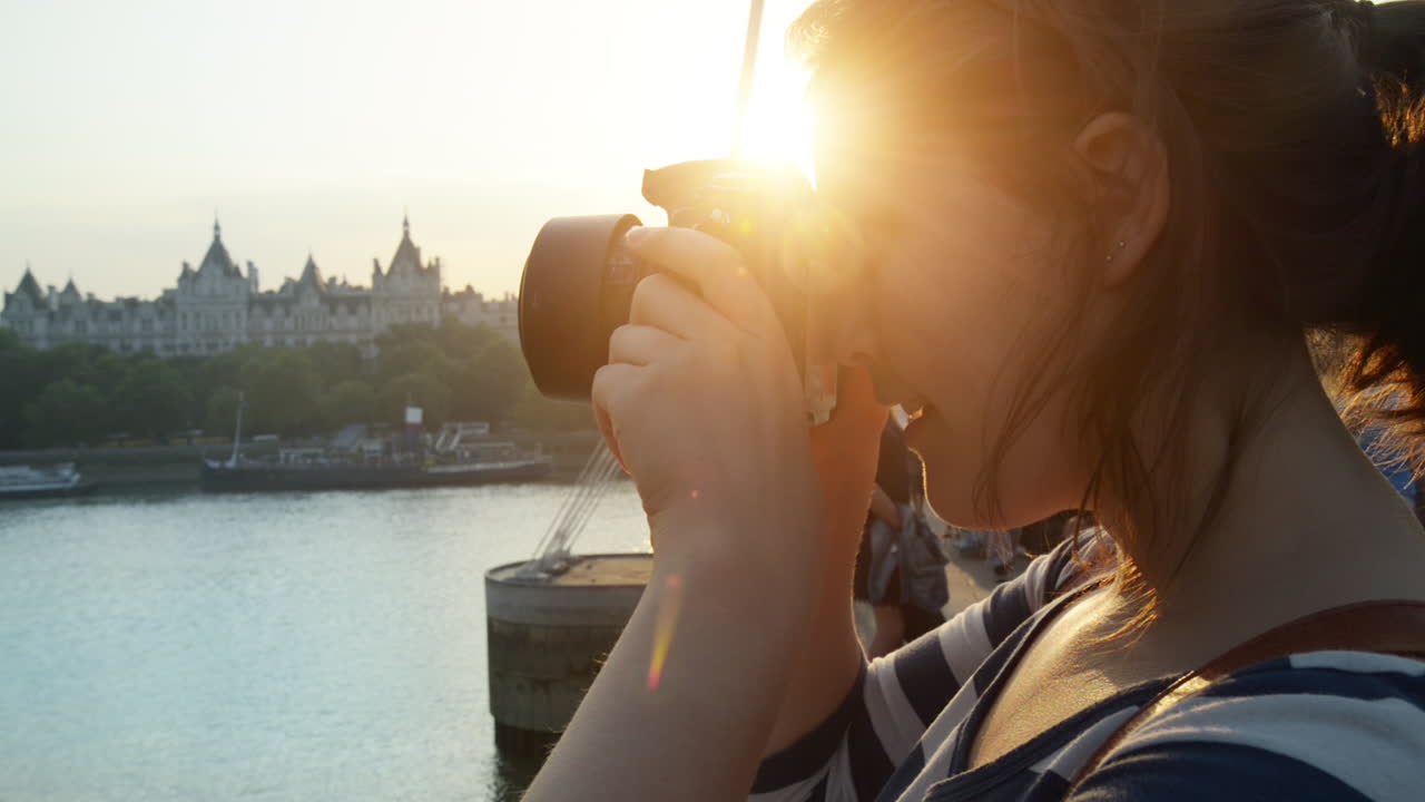 Tourist travel photographer photographing London city at sunset