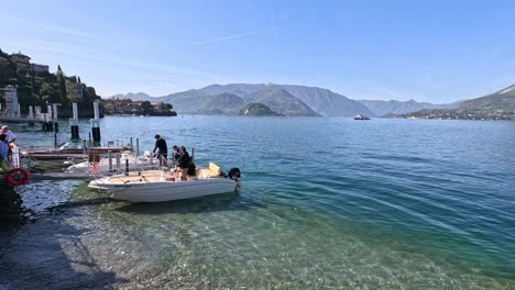 people docking a boat at lake como