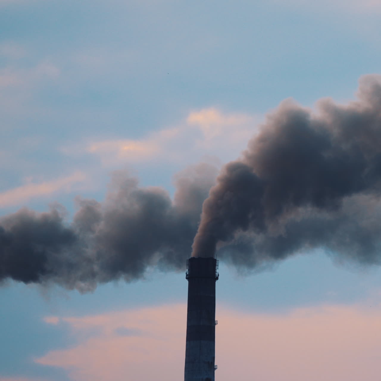 Pipe with smoke from industrial production polluting the air. Dense smoke comes from industrial pipe. Dirty smoke comes from the pipe into the atmosphere. Close-up.