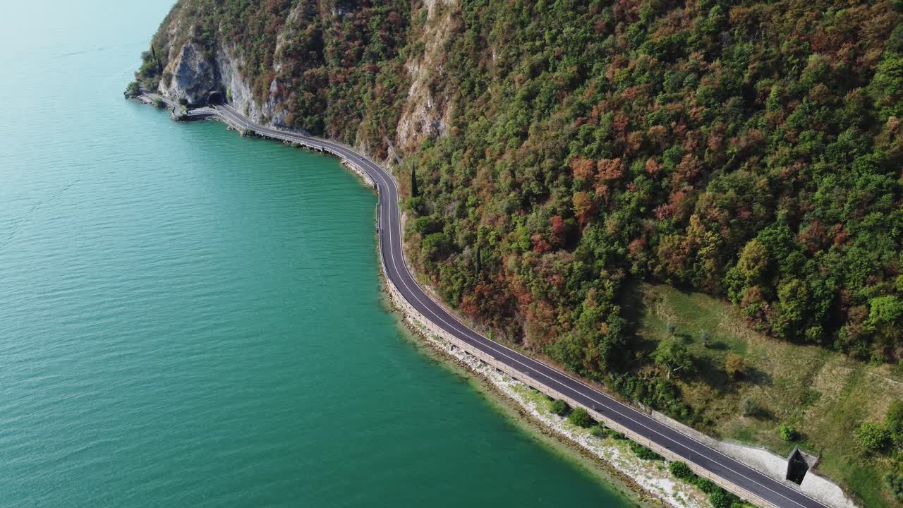 drone fly above Iseo lake, also known as Sebino, is the fourth largest lake in Lombardy revealing scenic panoramic road