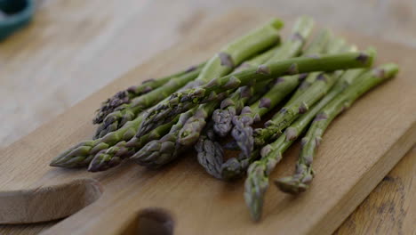 fresh asparagus on a wooden cutting board