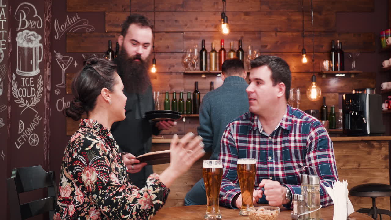 People having drinks and food at the bar