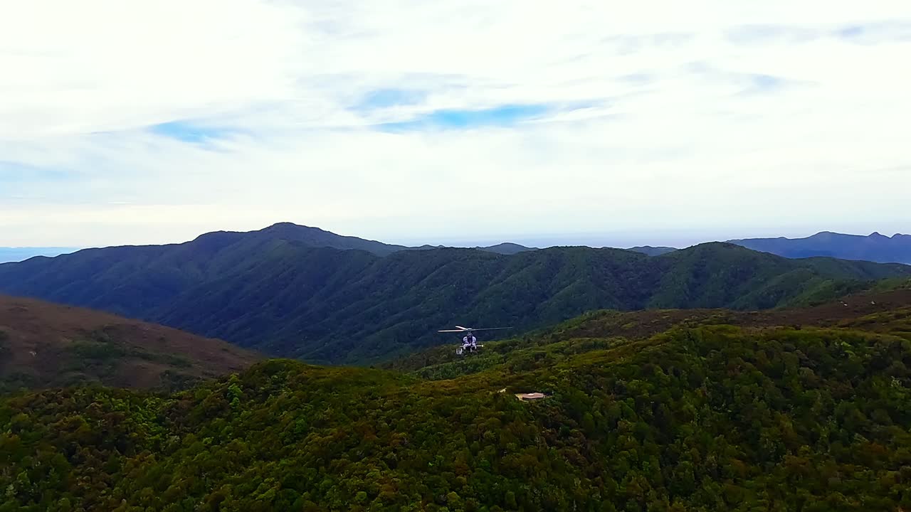 Helicopter flying over Rangitoto ki te Tonga, D'Urville Island, Marlborough sounds, New Zealand