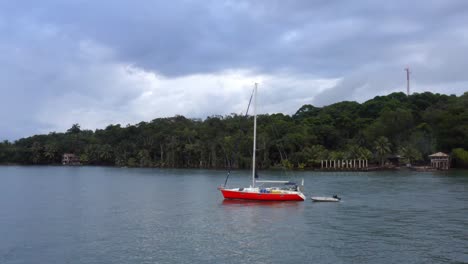 yacht and speedboat sit idle as sun descends over coastline