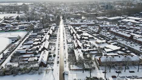 Aerial-of-van-driving-onto-main-road-on-a-sunny-winter-day