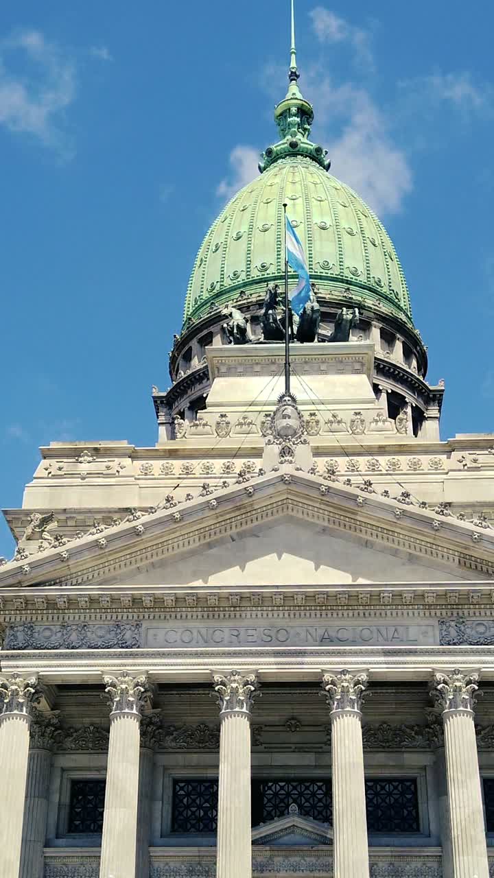 Argentine National Congress building in Buenos Aires vertical establishing of flag and front entrance on sunny day