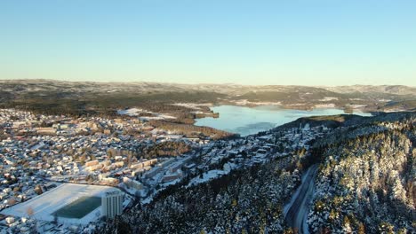 an aerial video of maridalen lake in oslo, norway in winter