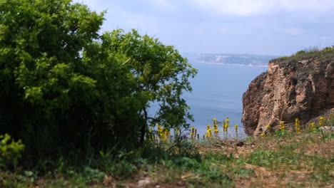 Revealing-shot-of-a-sea-and-hills-during-cloudy-summer-day