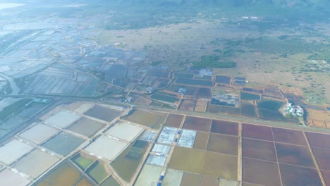 the hon khoi salt fields aerial view, located in nha trang where mounds of natural salt are manually harvested from shallow fields along doc let beach, vietnam