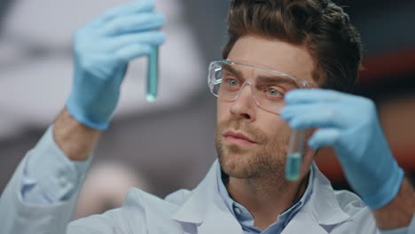 smart researcher exploring medicines in laboratory close up. serious scientist
