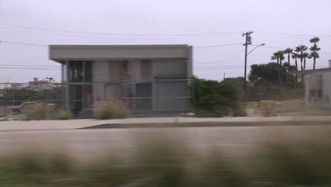 A-Car-Travels-Along-Pacific-Coast-Highway-As-Seen-Through-The-Side-Window