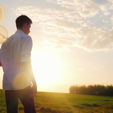 A-Teenager-In-A-White-Smart-Shirt-With-Balloons-In-His-Hand