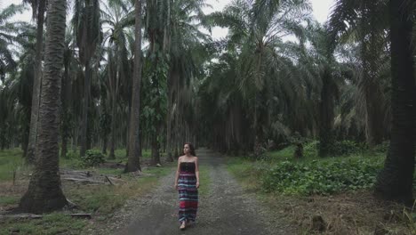 Süße-Frau-Mit-Langen-Haaren,-Die-Auf-Der-Straße-Zwischen-Palmen-In-Costa-Rica-Spaziert