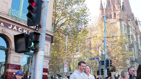 people crossing street near historic building