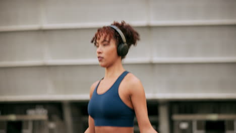 woman running outdoors with headphones