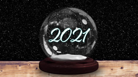 Animation-of-snow-falling-over-snow-globe-with-2021-text-on-black-background