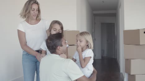 Two-girls-running-to-dad-and-hugging-him