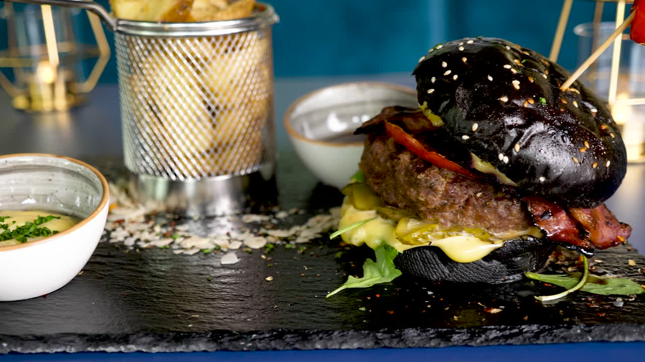 Black burger with fries