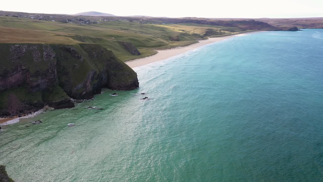 disparo de un dron desde los acantilados de la playa de traigh mhor con el pueblo de tolsta y la playa de garry al fondo en las islas hébridas exteriores de escocia