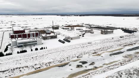 snow covered water treatment plant location, winter in silute, lithuania, drone flight