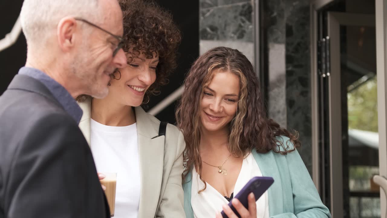 Cheerful business professional using cellphone during coffee break