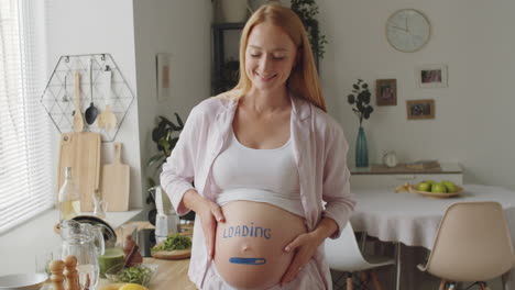 funny pregnant woman with "loading" message on belly