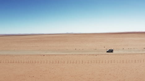 4x4-Safari-Vehicle-Travelling-Across-The-Desert-Of-Namibia-On-A-Sunny-Weather