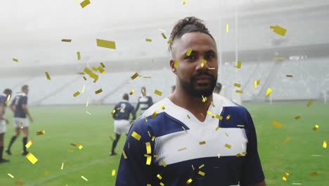 Animation-of-gold-confetti-falling-over-mixed-race-male-rugby-player-looking-at-the-camera-