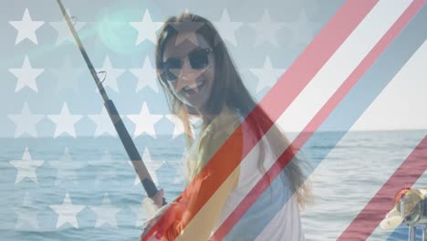 American-flag-design-pattern-against-portrait-of-caucasian-woman-holding-a-fishing-road-on-a-boat