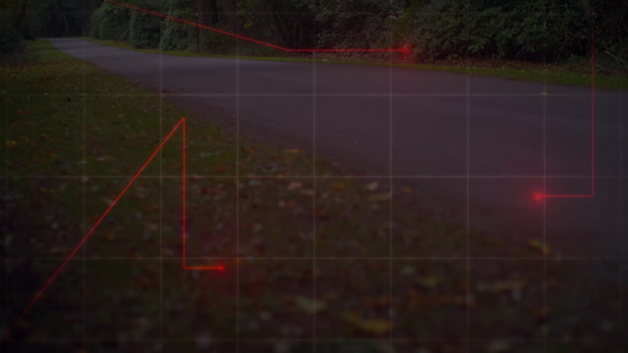 Red lines and grid animation over road and grass with fallen leaves